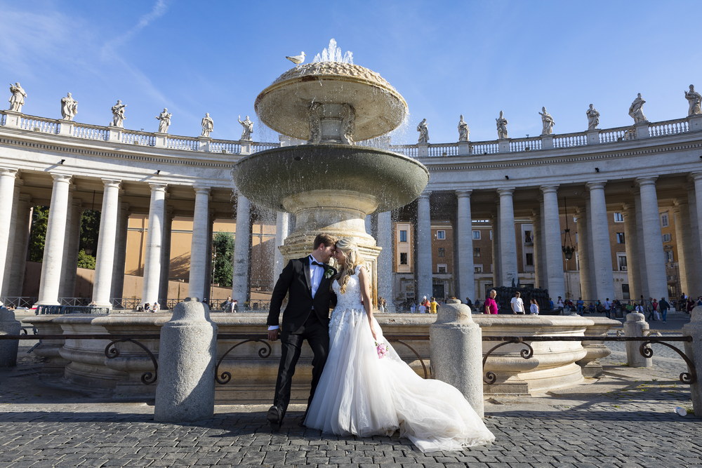 Picture taken of the just married couple underneath the water fountain found in Saint Peter's square
