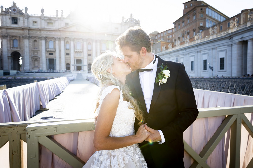Kissing the bride under the Basilica of Saint Peter in the Vatican Rome