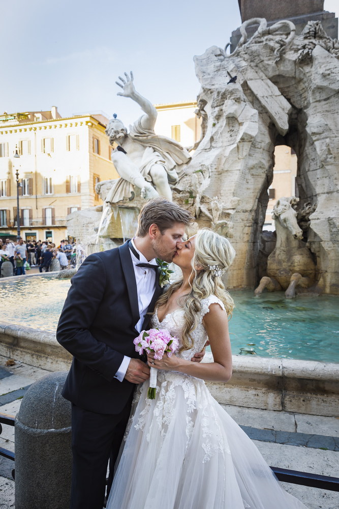 Kissing under the statue in Piazza Navona Rome Italy
