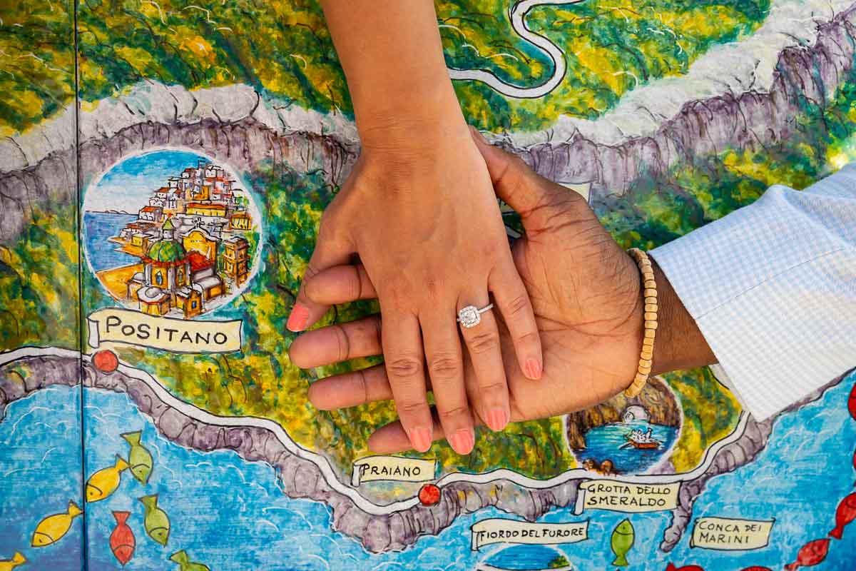 Closeup of the engagement ring photographed over a map of the Amalfi coast in Italy