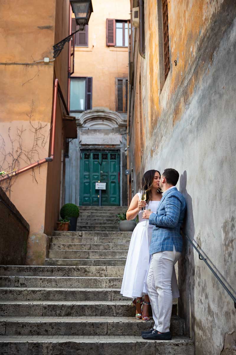 Hanging out on a staircase sipping prosecco wine during a couple photoshoot in Rome Italy