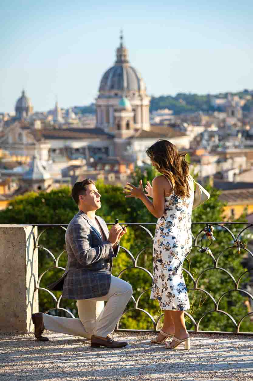 Proposing in the city of Rome overlooking the roman rooftops in the far distance at dusk. Rome view Proposal