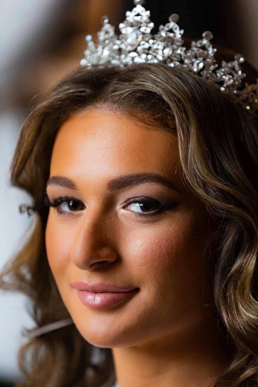 Bride portrait in color looking back at the camera. Image taken during the make up and hairstyle preparation