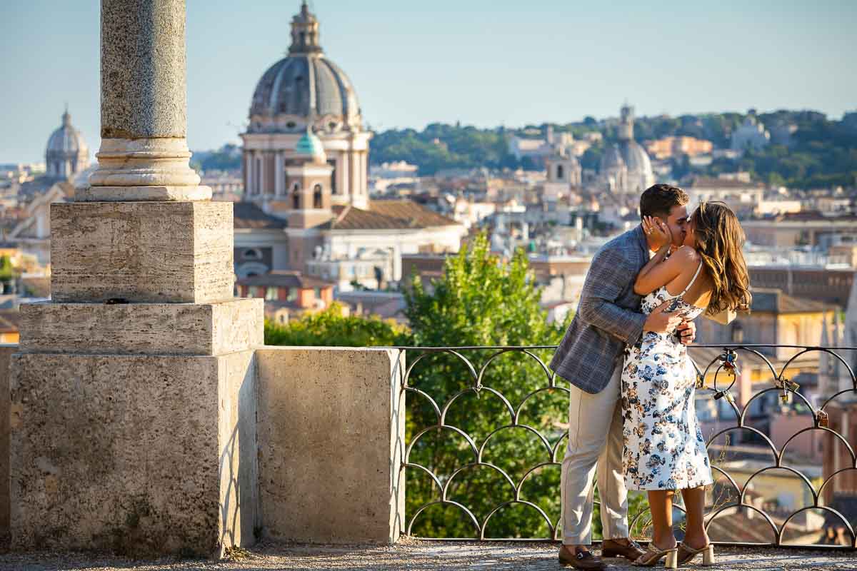 Kissing during a photography session in Rome Italy at the Pincio park terrace. Image by the Andrea Matone photographer studio
