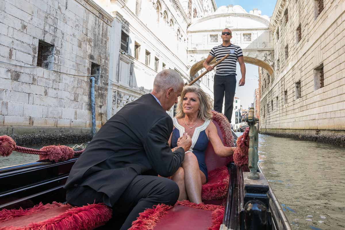 Surprise Wedding Proposal asked underneath the bridge of sighs in Venice Italy candidly photographed and video recorded by a photographer from inside the gondola