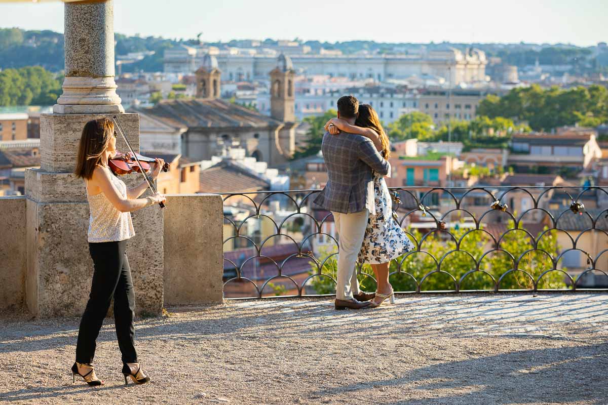 Violinist playing music during a Surprise Wedding Proposal photographed in Rome Italy 