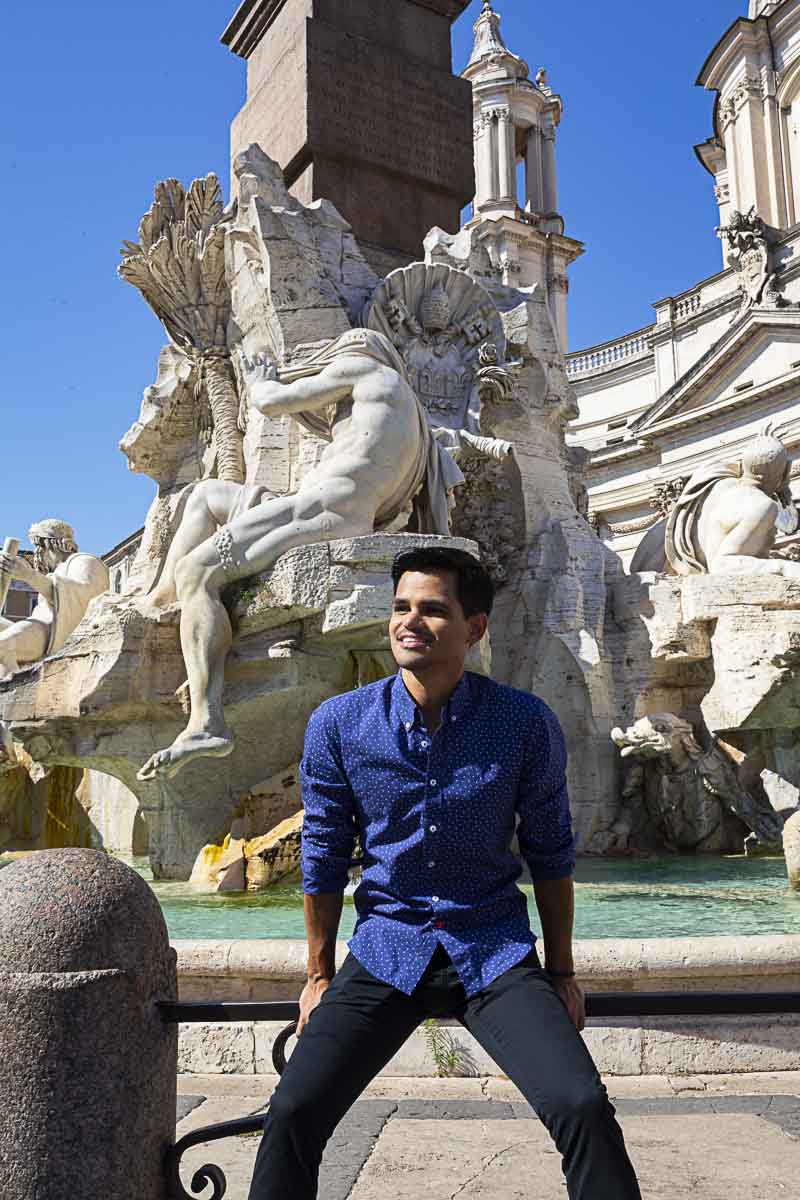 Sitting on the edge of the water fountain while taking creative and unique model photography in Rome Italy