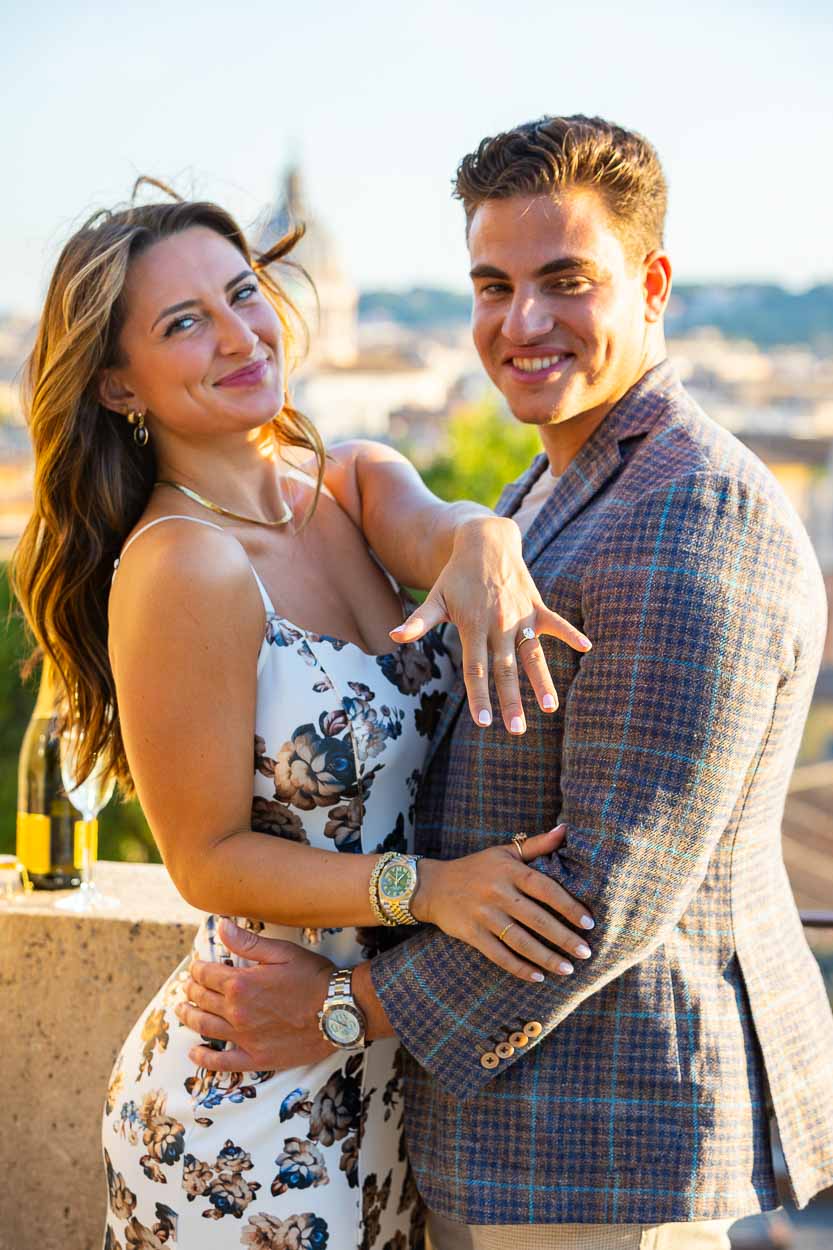 Just Engaged showing off the engagement ring to the photographer's camera taking pictures during a photoshoot in Rome