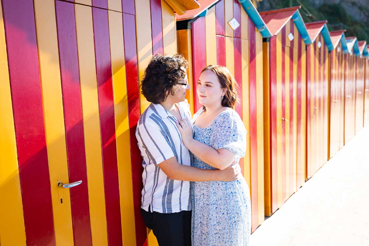 Picture portrait snapped by colorful cabins at the beach. Sorrento wedding proposal photography at a beach resort 