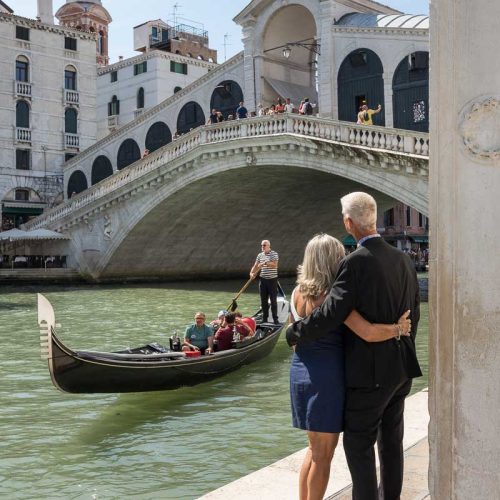 Looking at the Rialto bridge as gondola slowly float by on Canal grande