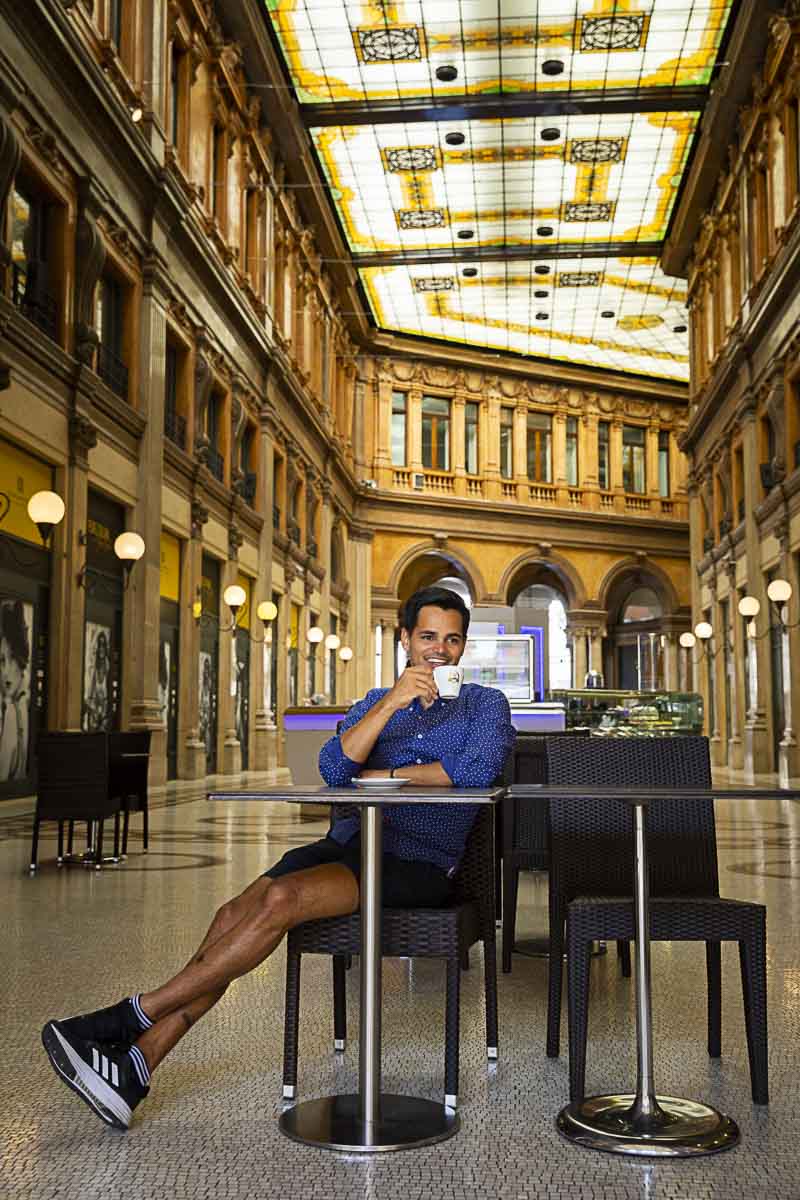 Taking portrait pictures while savoring an Italian cappuccino coffee while posing for a male model photography