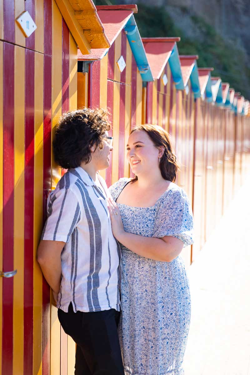 Closeup portrait in sunlight over typical changing cabins that are found by the beachside 