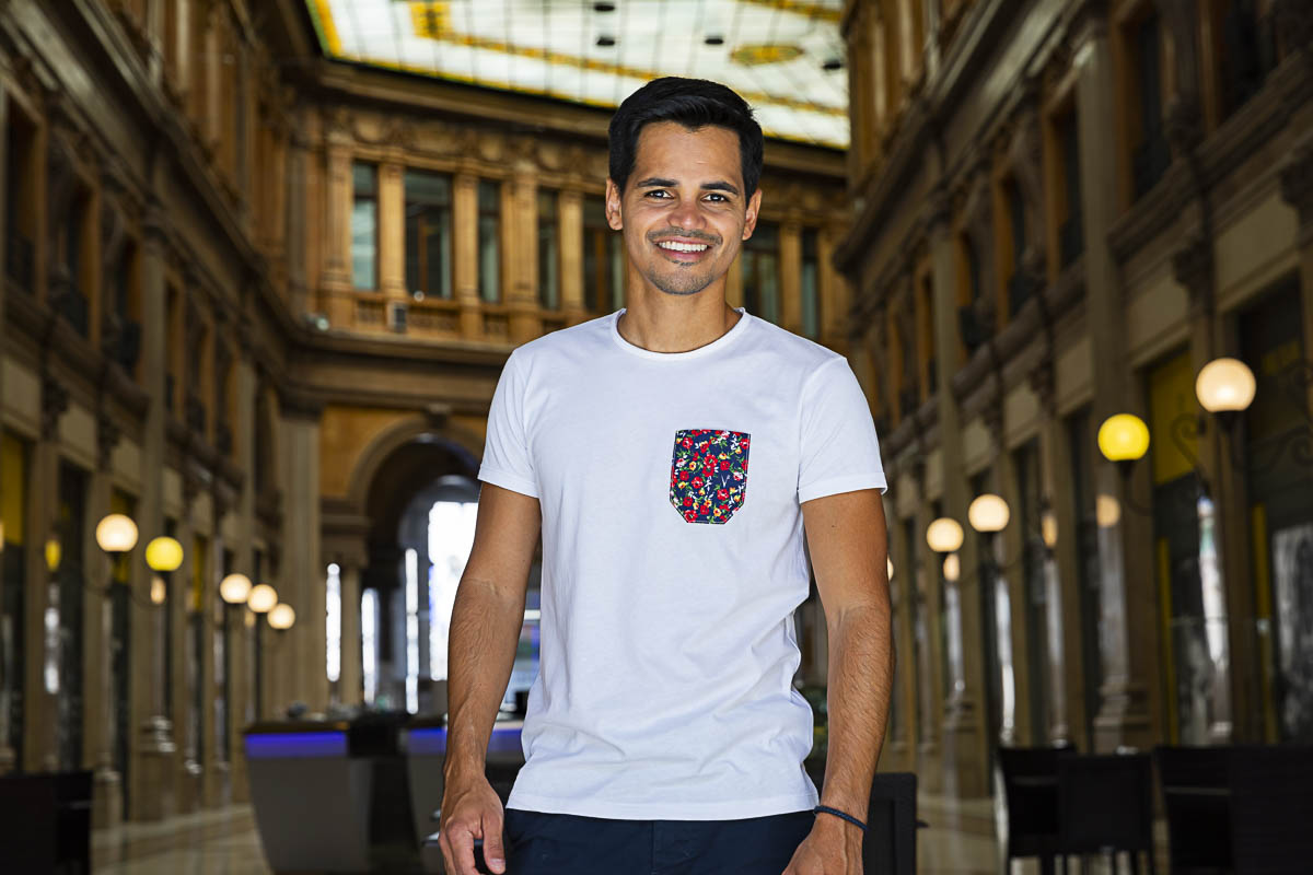 Up close male model portrait smiling and looking into the camera in an Italian gallery setting