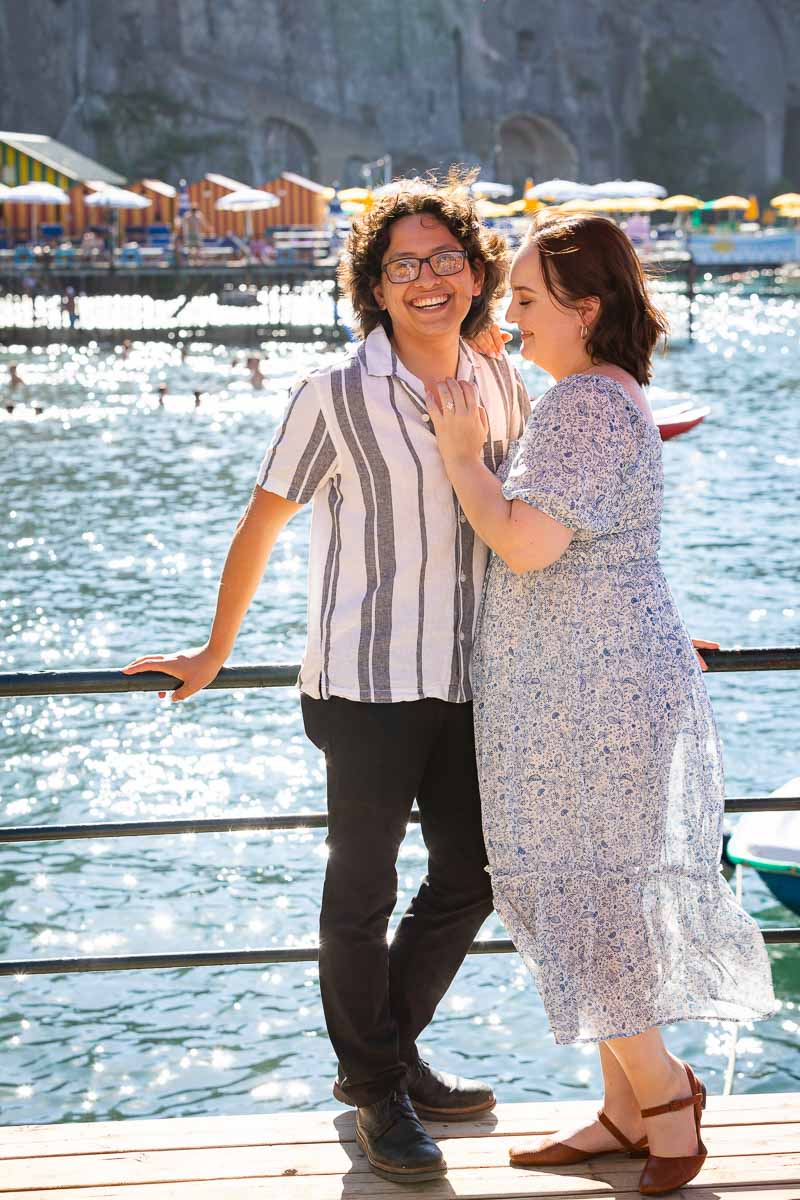 Posing in front of the sea with the sun shining over it while smiling and enjoying the moment. Sorrento Wedding Proposal