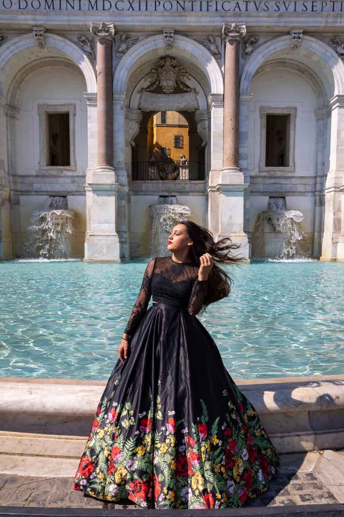 Model posing by the Janiculum hill fontanone water fountain and looking sideway. Fashion photo shoot in Rome Italyfountain