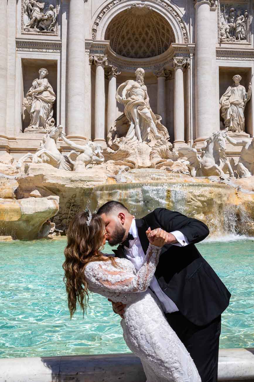 Romantic kiss at the Trevi fountain during a wedding photo shoot in Rome Italy