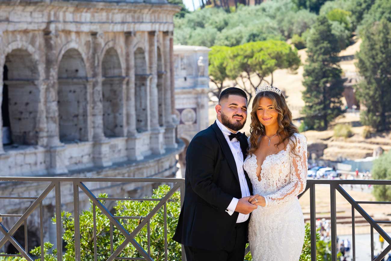 Bride and groom portrait taken at the Roman Colosseum at the end of the wedding day in Rome