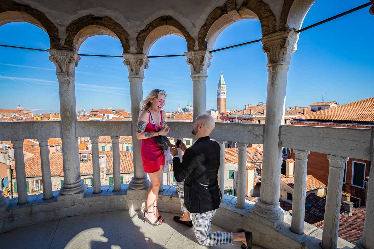 Man proposing marriage inside the Contarini del Bovolo tower in Venice Italy