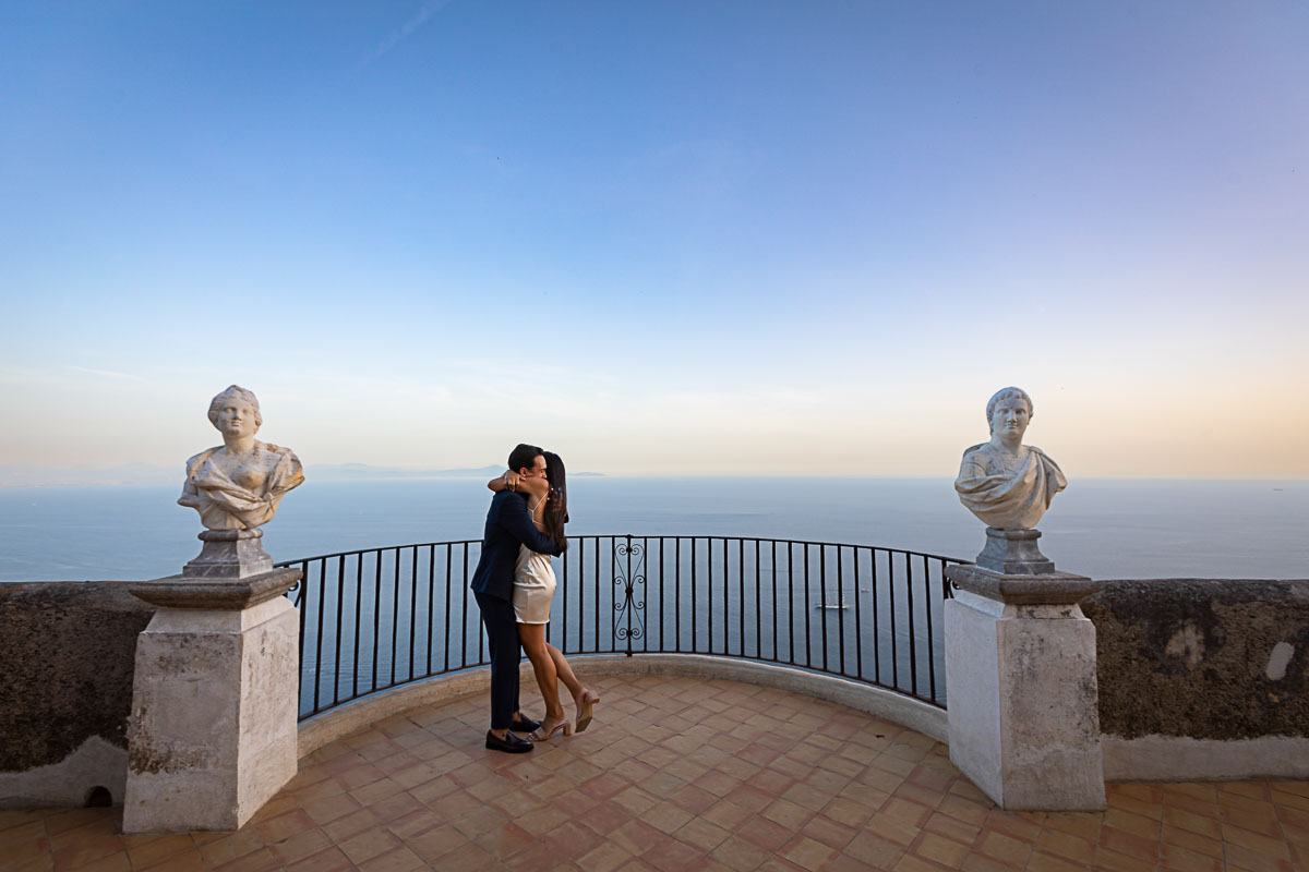 Embracing after a wedding proposal on the Infinity terrace of Villa Cimbrone, Italy