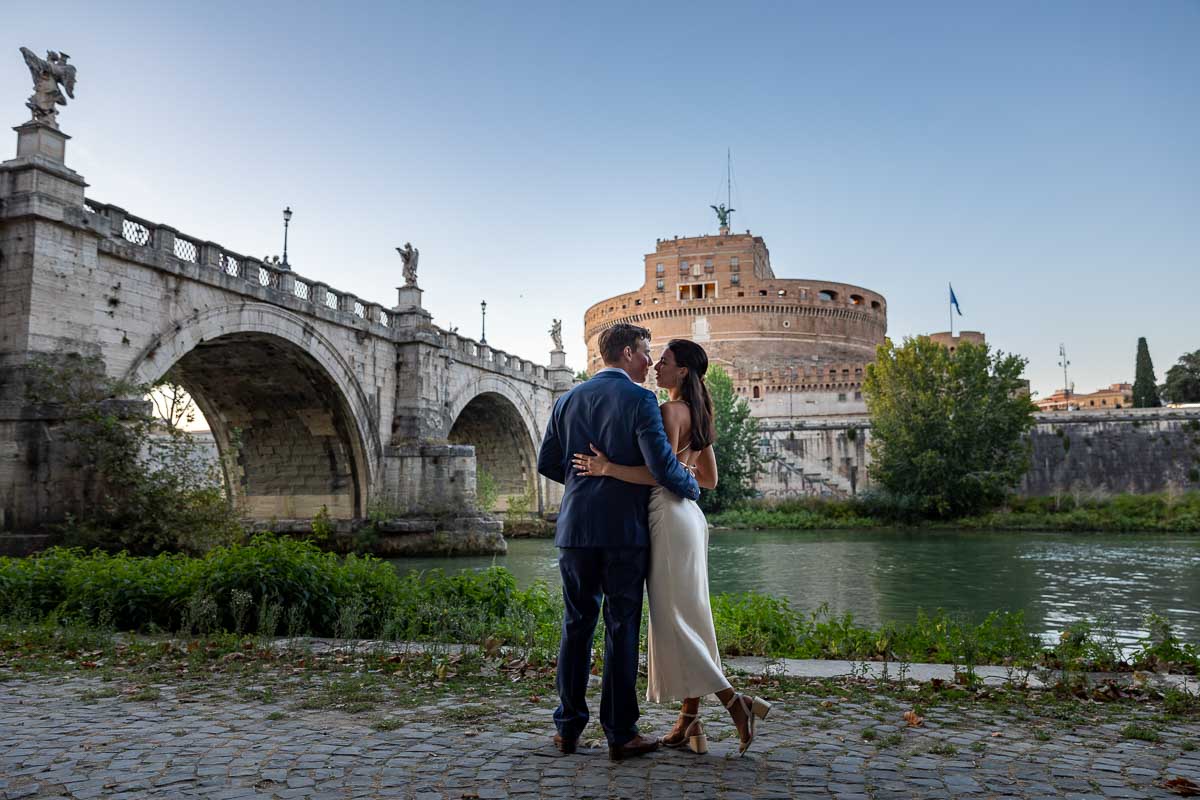 Couple portrait photographed at the Castel Sant'Angelo bridge in Rome Italy during an engagement photo shoot