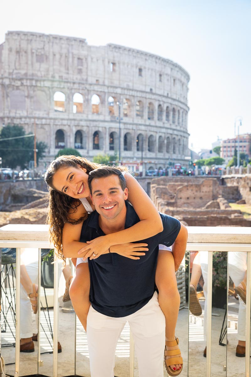Couple on a piggy back ride during an angagement photoshoot in Rome Italy
