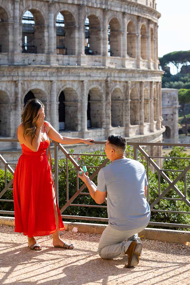 Proposing marriage in front of the majestic view of the Roman Colosseum in Rome Italy