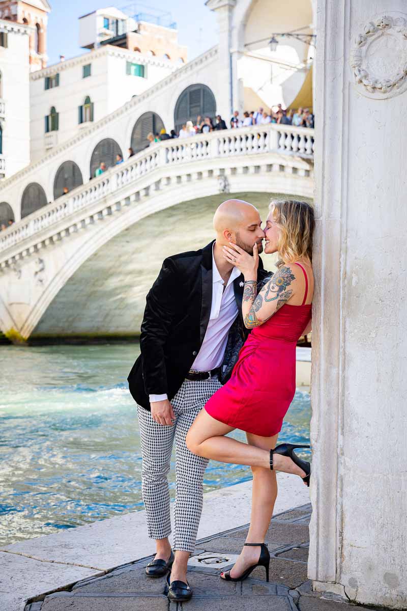 Leaning on the a side building holding a pose during a couple photoshoot in Venice Italy with the Grand Canal in the background