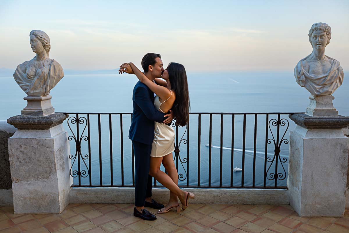 In Love in Ravello posed picture in between tow ancient marble statue and a unique view over the Mediterranean sea in Italy