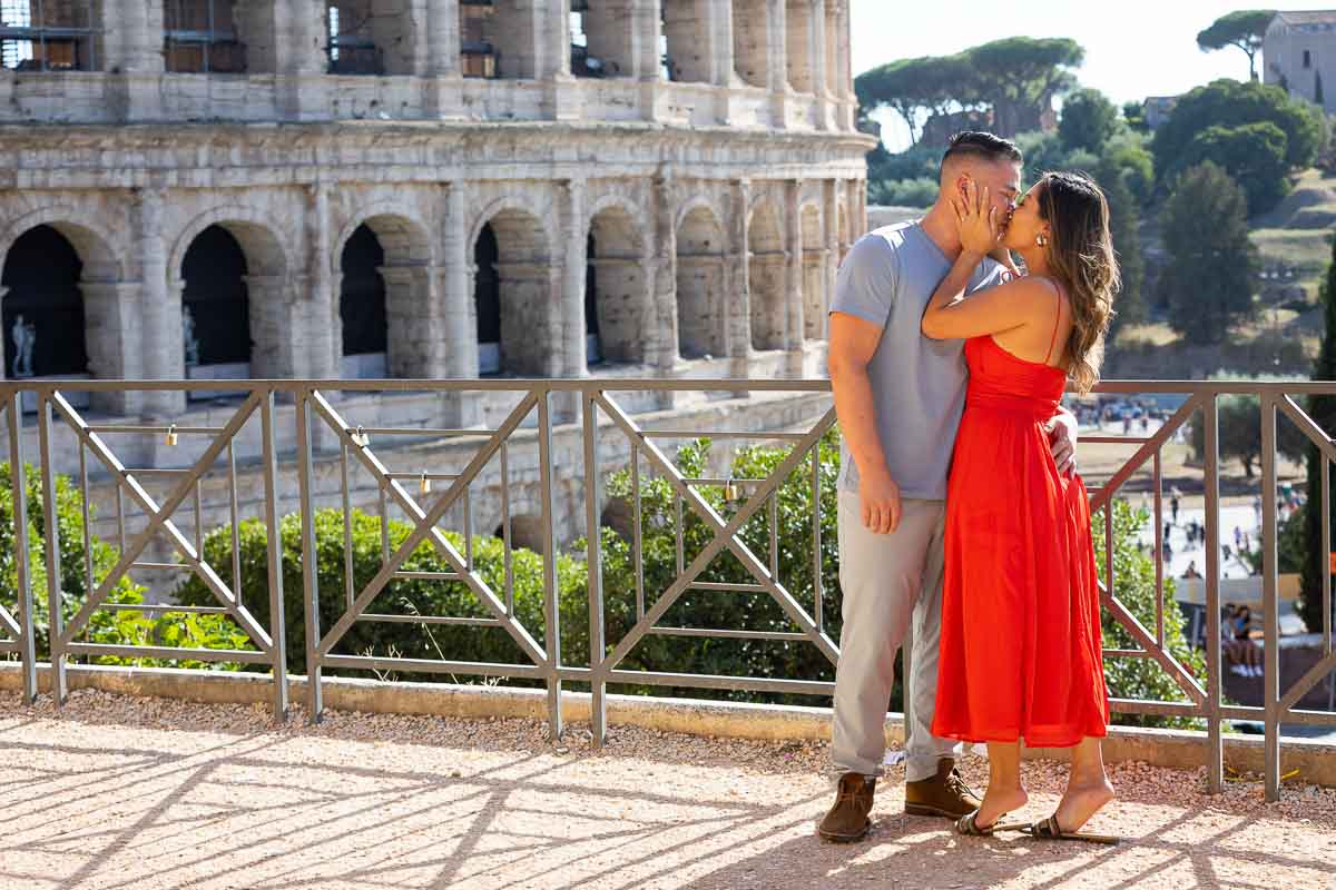 Couple kissing during an engagement photoshoot at the Colosseum in Rome
