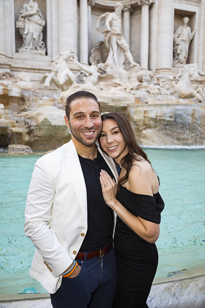 Couple portrait standing before the water of the Trevi fountain 