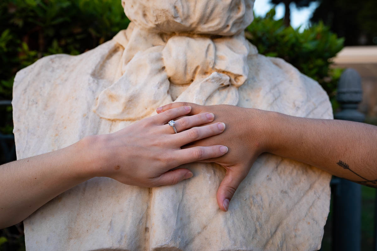 Engagement ring pictures photographed over a white marble statue