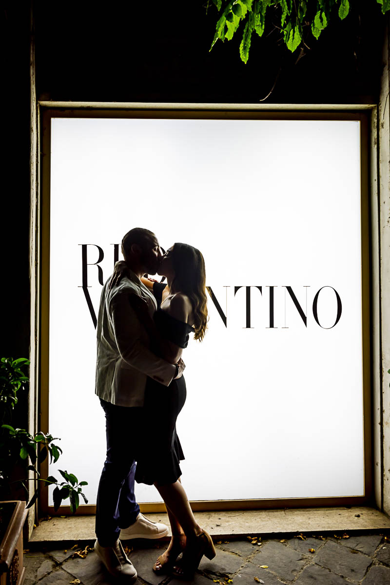 Kissing in front of the Valentino Red showcase 