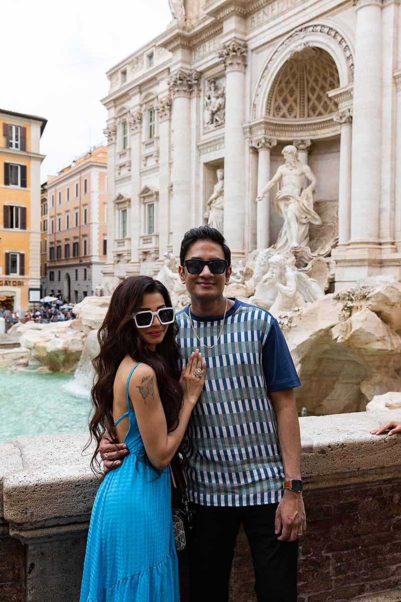 Couple photography posing in front of the Trevi fountain in Rome, Italy