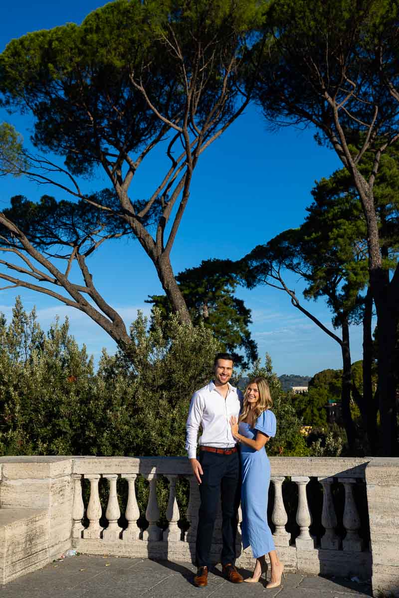 Couple portrait posing under Mediterranean pine trees in Villa Borghese