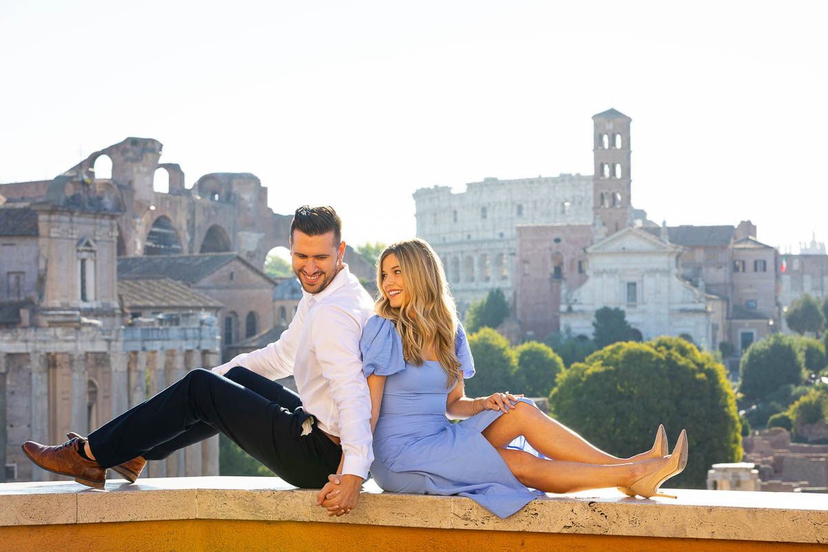 Sitting down on a marble wall with the Coliseum in the far distance