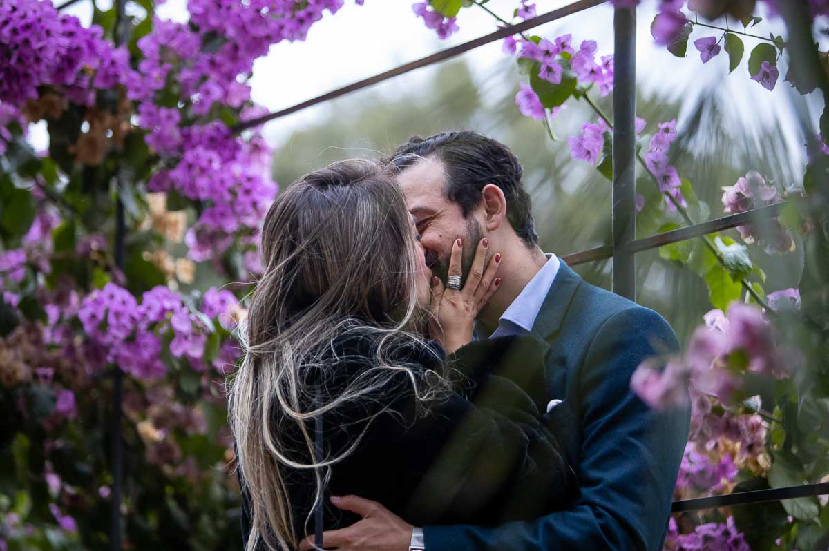 Couple kissing among beautiful flowers