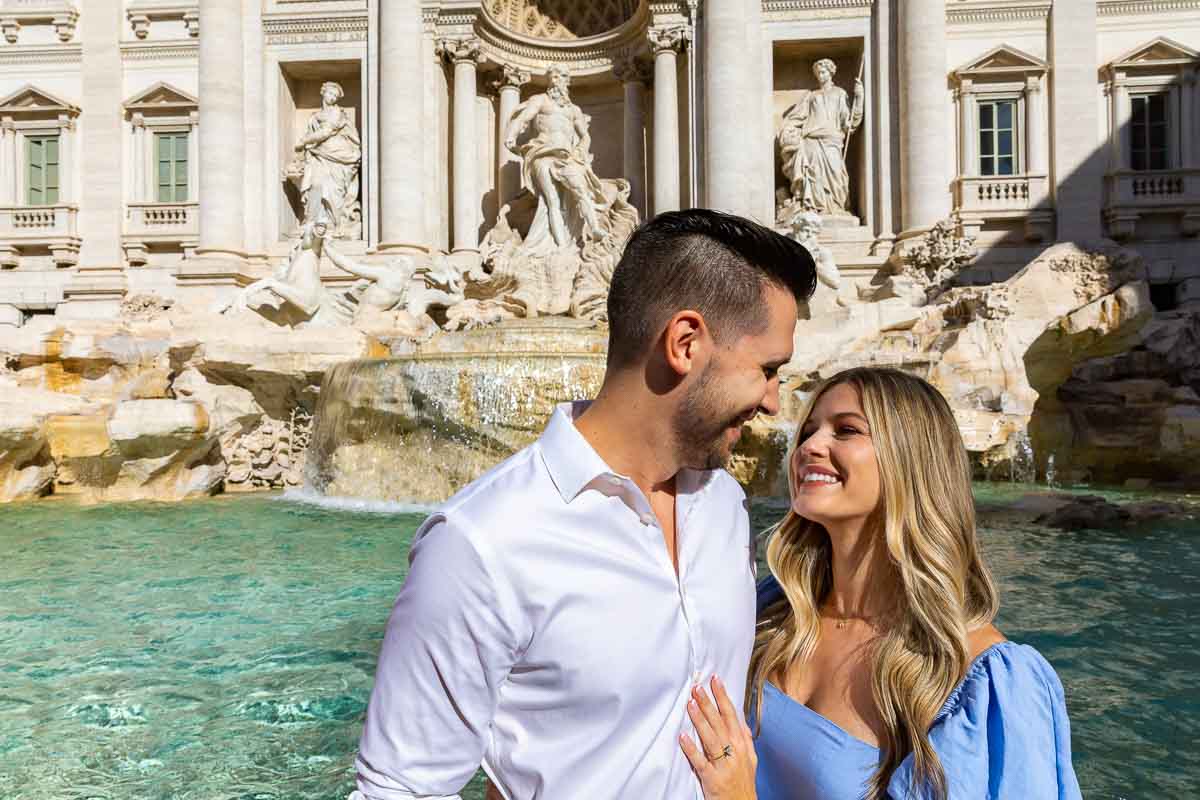 Couple taking engagement pictures at the Trevi fountain