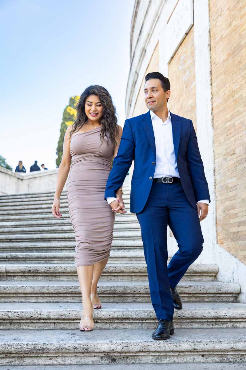 Couple walking down the spanish steps holding hands