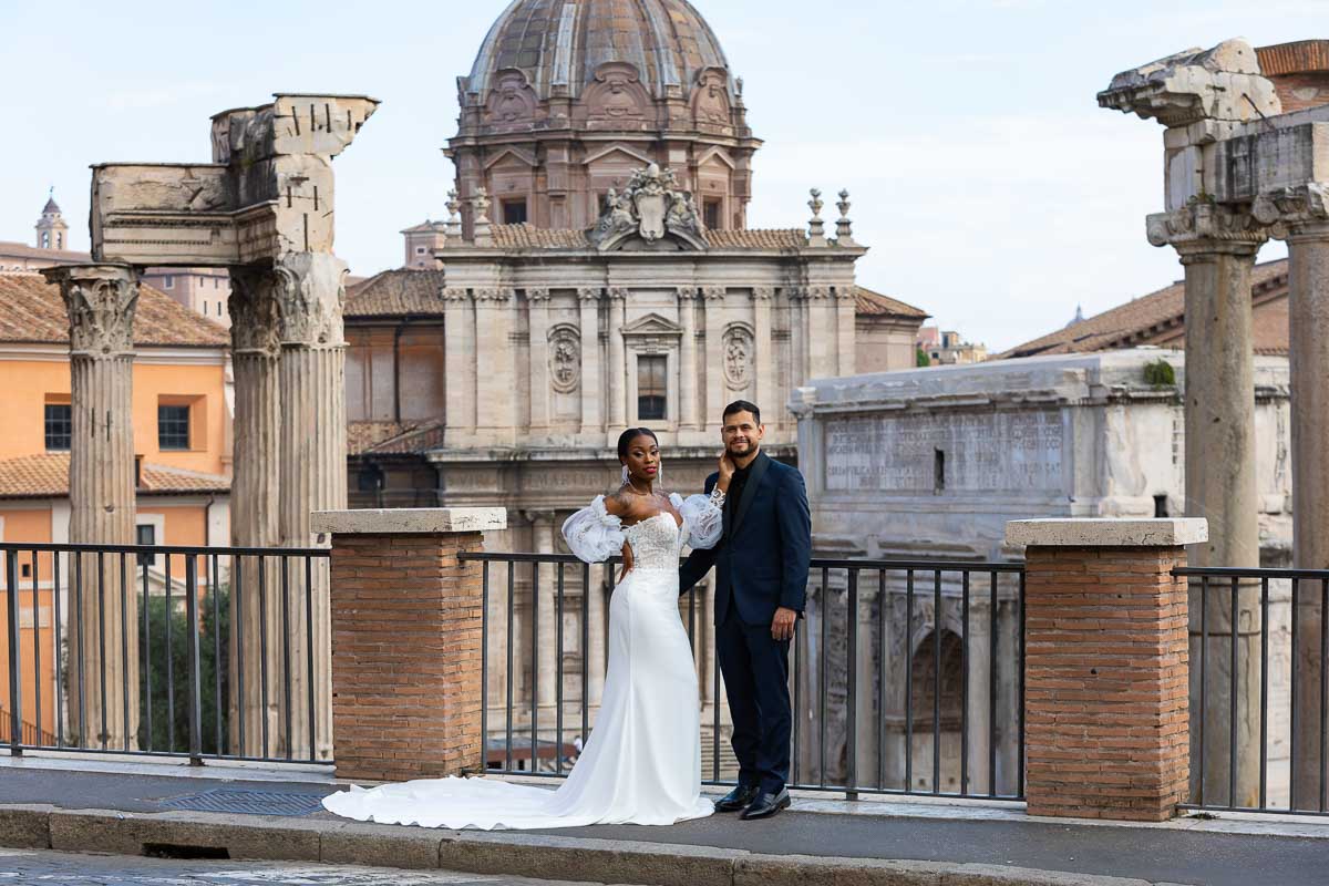 Bride and groom standing before the ancient roman forum taking their wedding pictures in Rome Italy