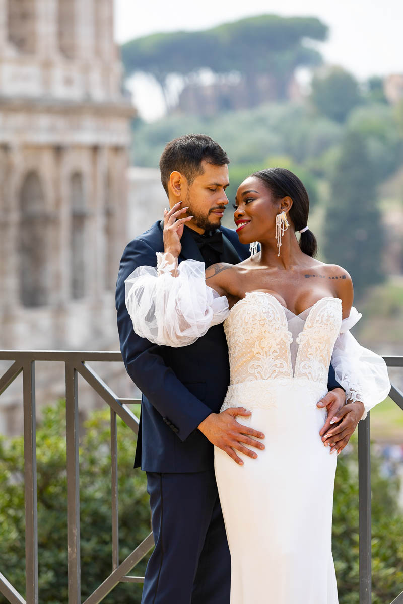 Wedding Couple in Rome. Final picture portrait of the groom posing together with the bride at the Coliseum