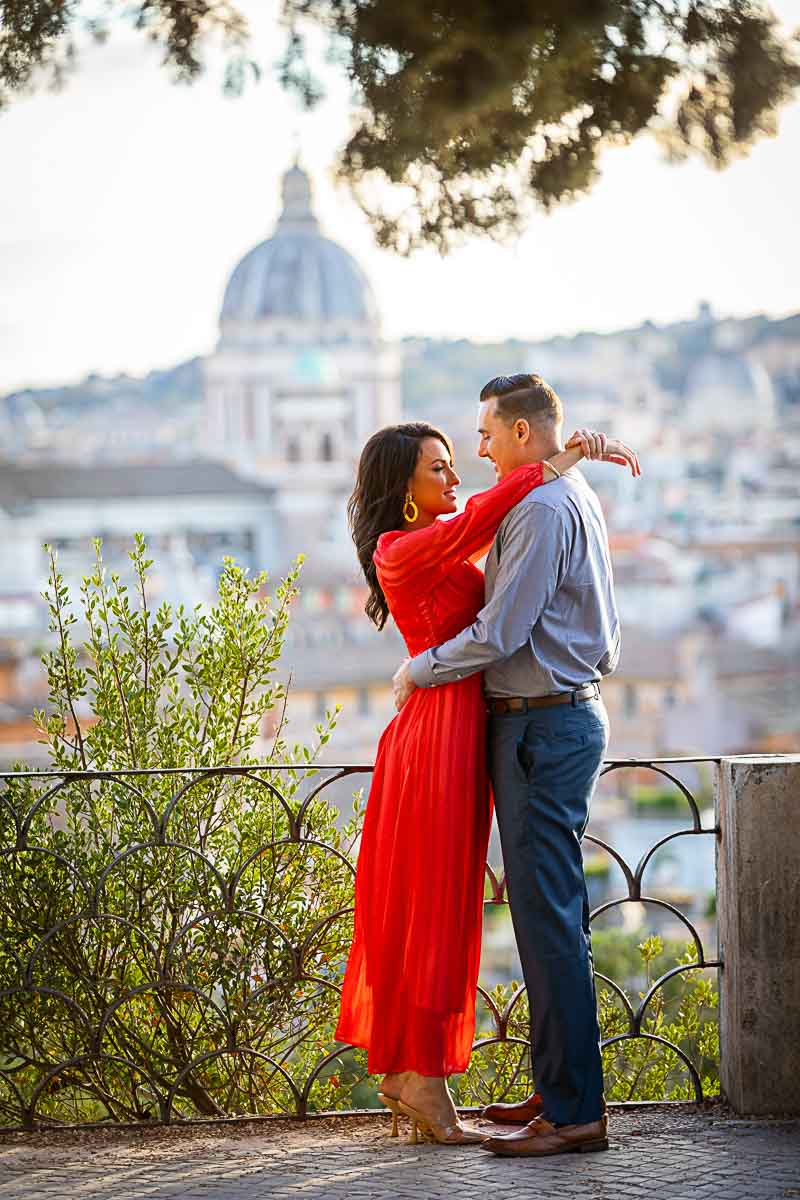 Red dress variant. Couple photoshoot in Rome Italy taken at sunset overlooking at the city skyline from above