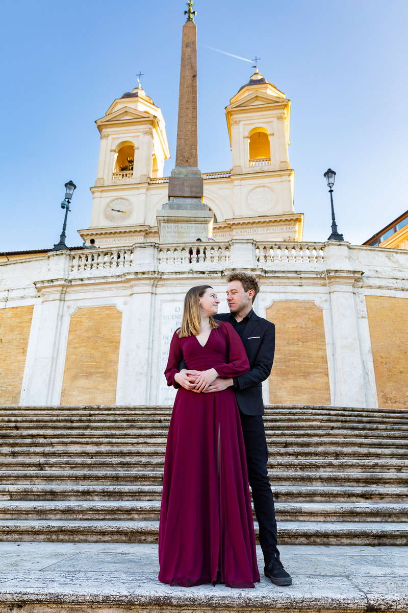Posing couple in front of the Trinita' dei Monti church. Piazza di Spagna. Roma