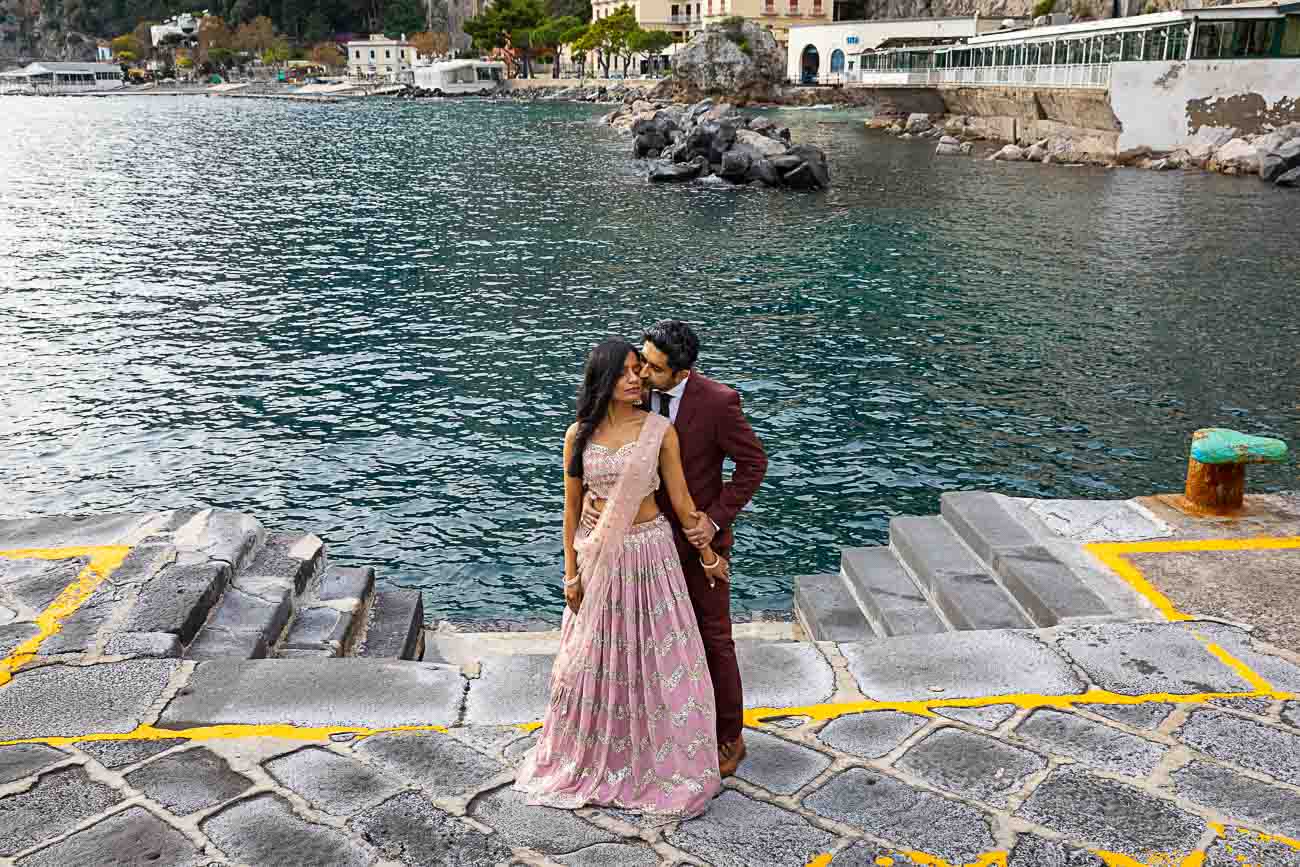 Marina grande port couples pictures in Amalfi with the dark blue sea in the back 