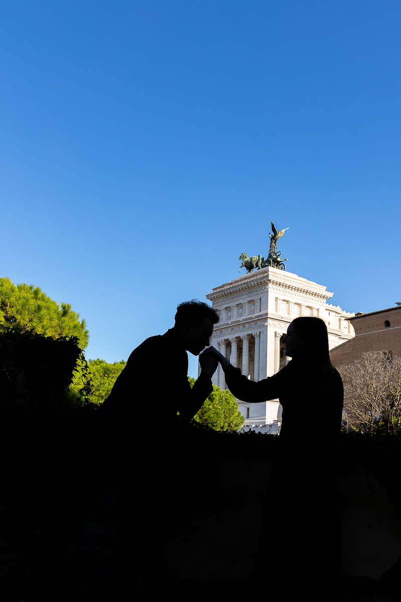 Gesture of chivalry while taking pictures on a roman engagement photo session 