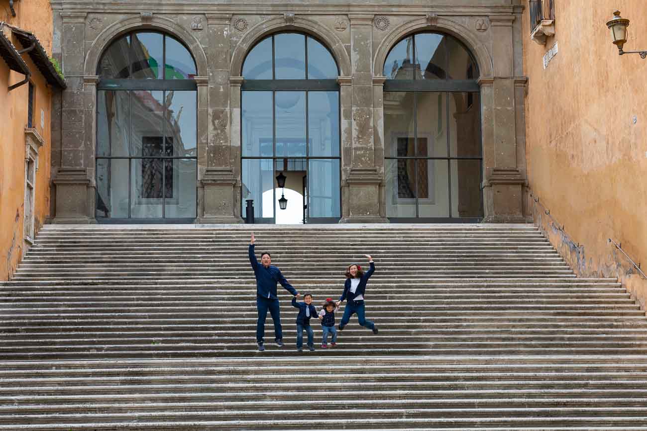 Jumping shot taken on the very large staircase found in Piazza del Campidoglio in Rome Italy during a family photo shoot in Rome