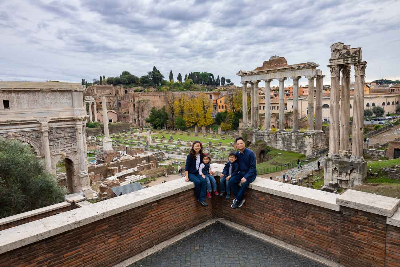 Family picture taken in front of the sweeping view of the Roman Forum in Rome Italy