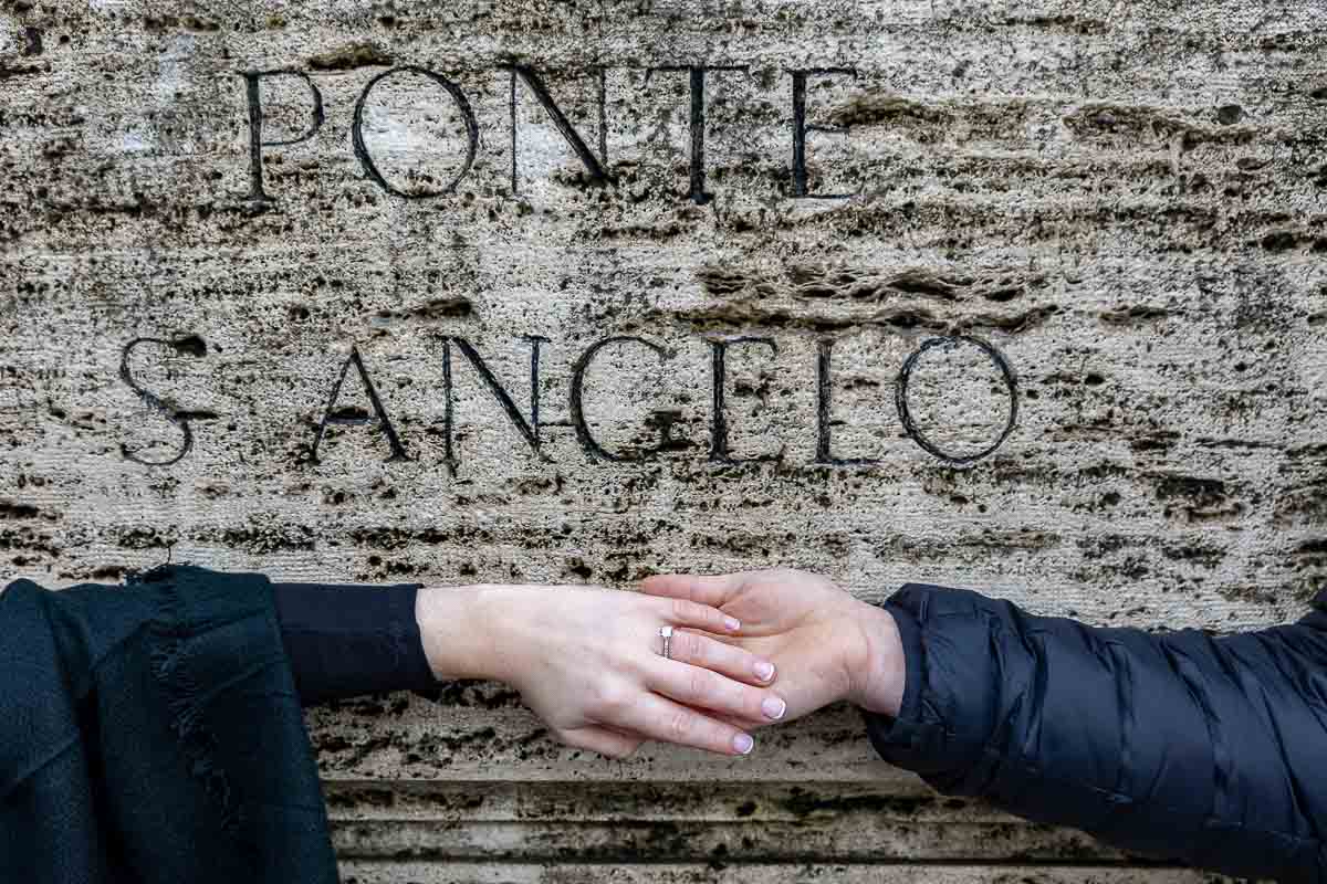 Close up image of the engagement ring photographed over the ancient bridge sign