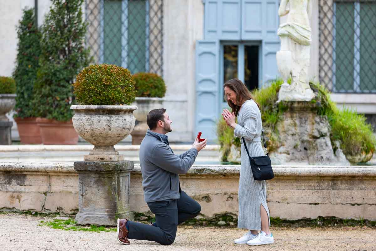 Surprise wedding proposal candidly photographed in front of the Galleria Villa Borghese museum in Rome Italy