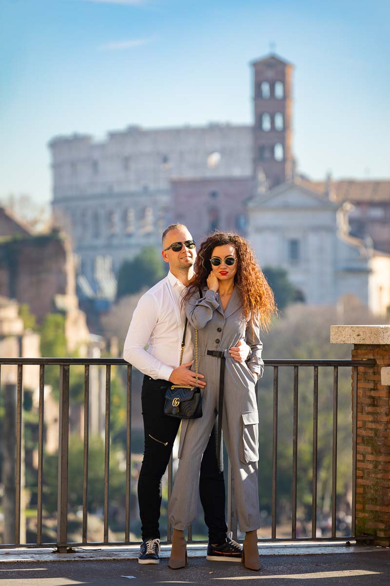 Posed couple photo shoot in Rome in front of the Colosseum in the far distance