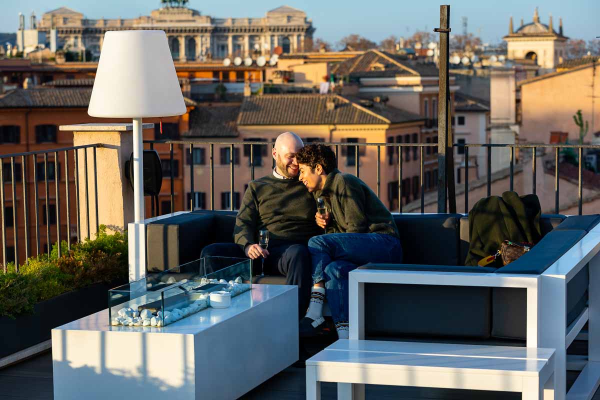 Couple hanging out on a terrace overlooking the city of Rome from above 